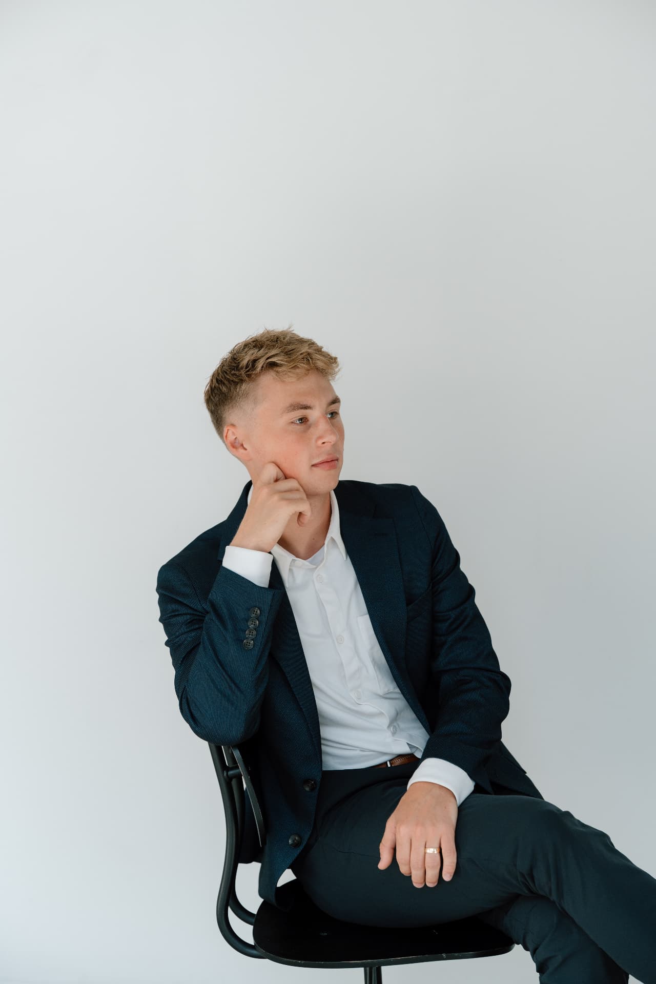 Matt Schertzer seated in a navy blazer, looking thoughtfully into the distance.